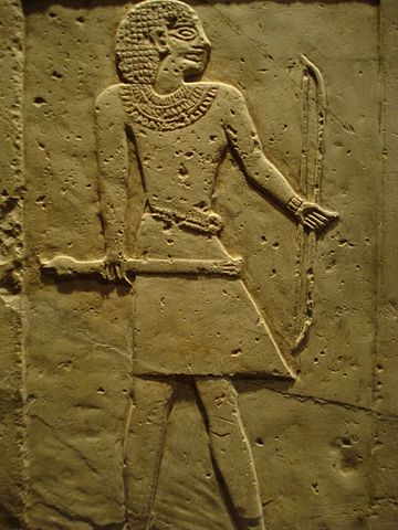 Grave stelae with a man in a loincloth carved in relief.