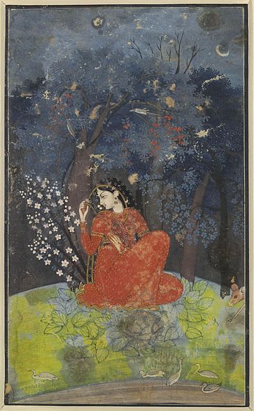 A woman in red is sitting on the ground beneath some trees.