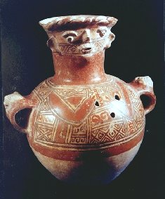 This urn is decorated with geometric shapes and a face at the top.