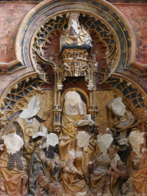 An alter piece with the figures defaced.
