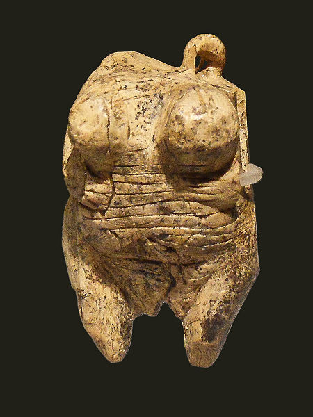 Photo of figurine depicting the form of a nude woman.
