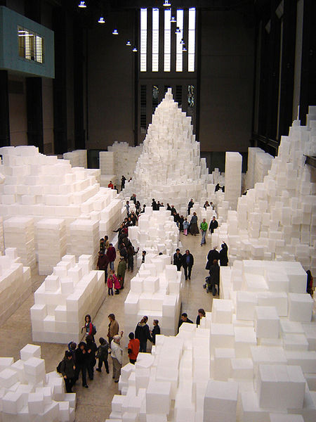 Photograph of art installation, which consists of 14,000 translucent, white polyethylene boxes stacked at varying heights.