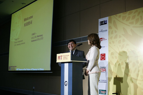 Two speakers are standing in front of a podium during the MIT Energy Innovation Panel.