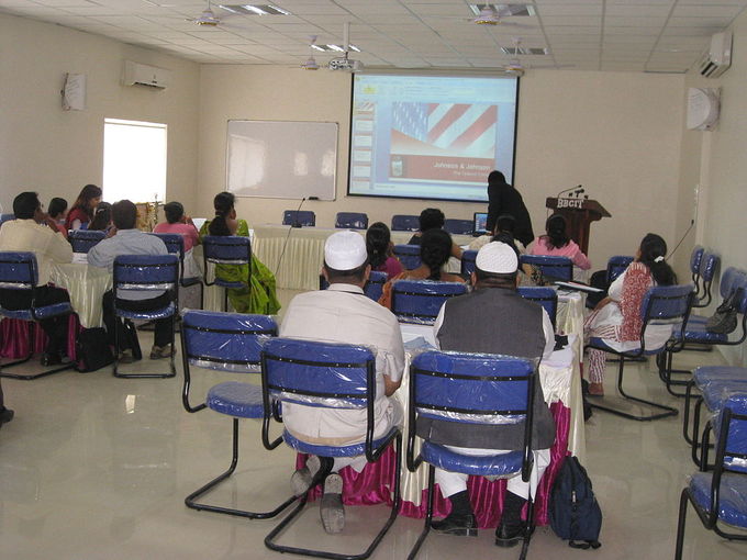 An audience views a PowerPoint presentation.