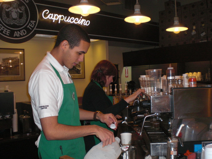 Baristas working in the first Starbucks coffee shop in Seattle, Washington.