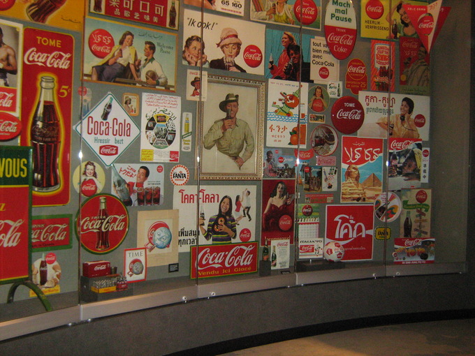 A display case that shows Coke signs from around the globe.