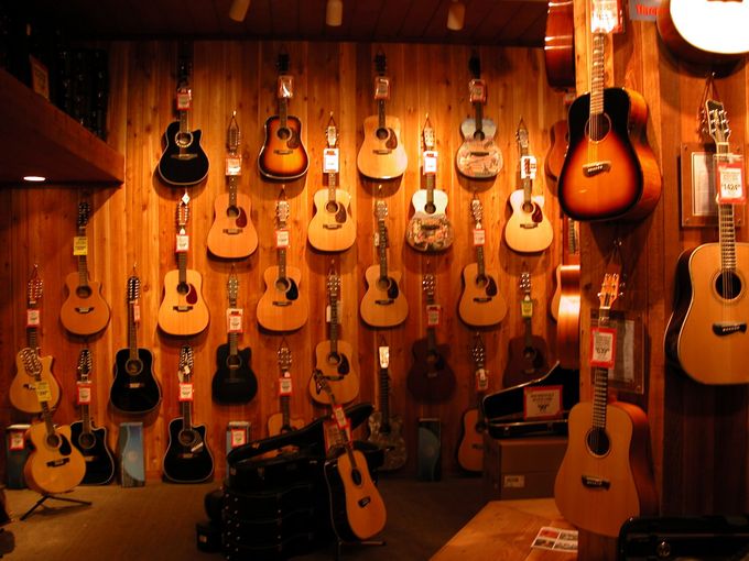guitars on the wall of a store