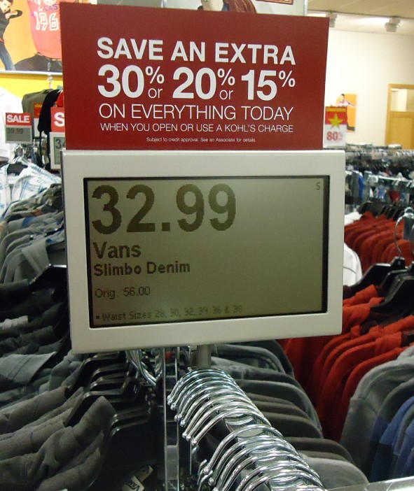 An electronic price display on a clothes stand at a retail store.