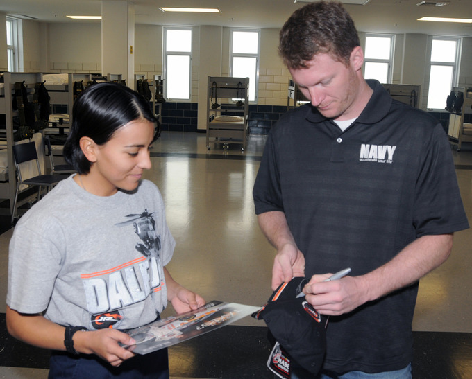 Dale Earnheart Jr. signing a woman's personal belongings
