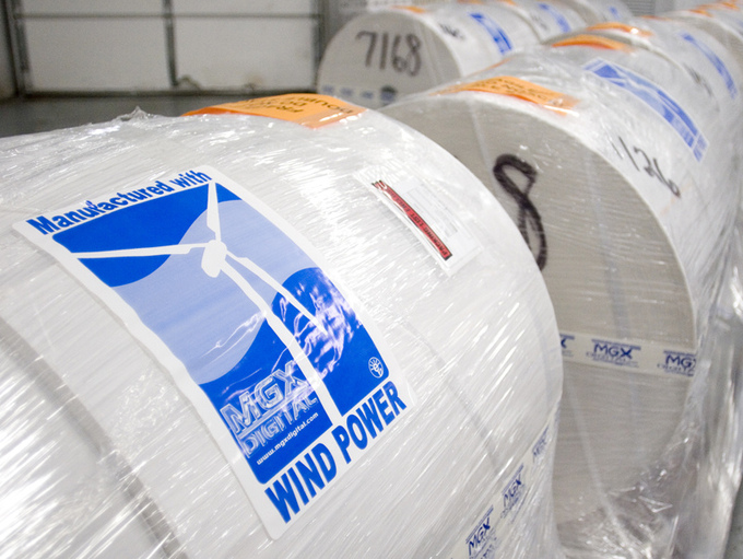 Large rolls of industrial paper that are packaged with a label that says