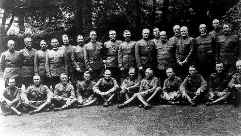 A photograph of about thirty uniformed men.