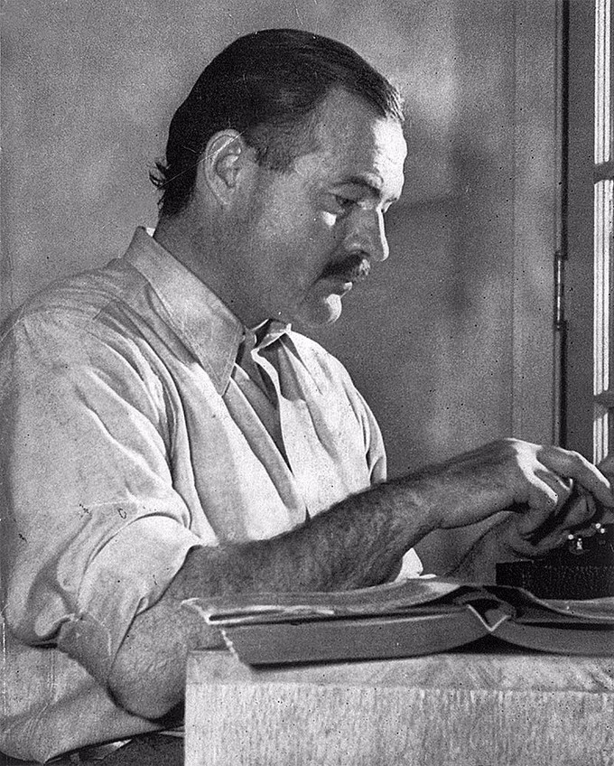 Photograph of Ernest Hemingway writing