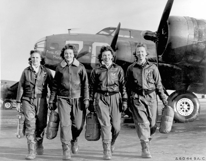 Four female pilots leaving their ship, Pistol Packin' Mama, at the four engine school at Lockbourne AAF, Ohio. The women were members of a group of Women Airforce Service Pilots (WASPS) who have been trained to ferry the B-17 Flying Fortresses.