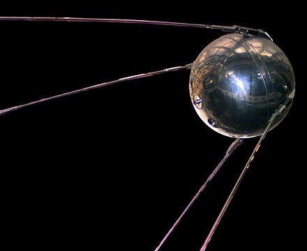 A photo of a replica of the Soviet satellite Sputnik, a silver orb which was the first satellite launched into space.