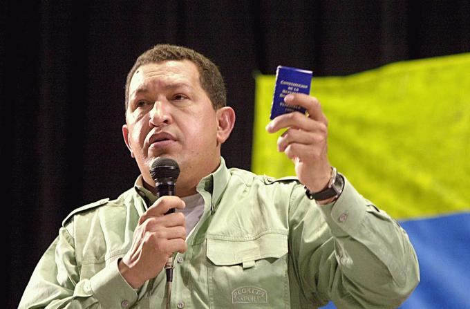 Chávez holds up a miniature copy of the 1999 Venezuelan Constitution at the 2005 World Social Forum held in Porto Alegre, Brazil.