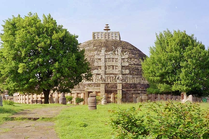 An image of a stupa built by Ashoka, a large dome building with images etched in the sides.