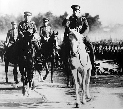 Emperor Shōwa riding his stallion Shirayuki alongside other military officers riding horses during an Army inspection, August 1938.