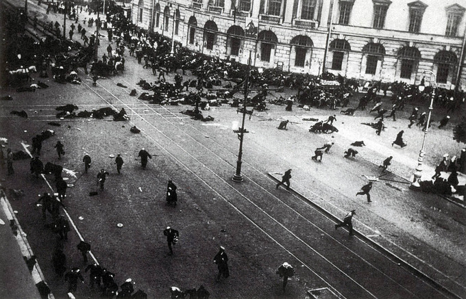Photo shows people strewn across a large open street, some running, some injured or dead.