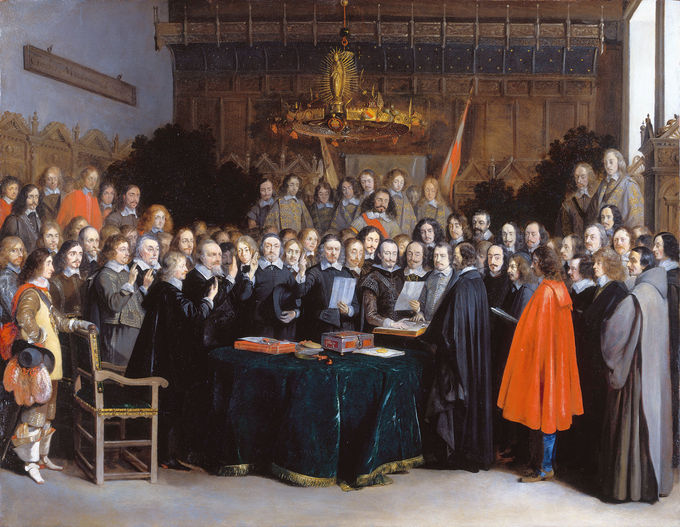 Painting of a large group of men overlooking a table containing the Treaty of Münster.