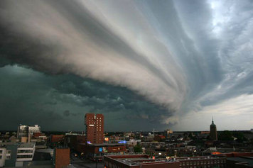 Storm clouds sweeping in over a city. The clouds are straight lines