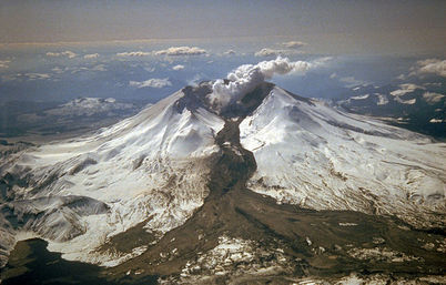 An explosive eruption on March 19, 1982, sent pumice and ash 9 miles (14 kilometers) into the air, and resulted in a lahar (the dark deposit on the snow) flowing from the crater into the North Fork Toutle River valley. Part of the lahar entered Spirit Lake (lower left corner) but most of the flow went west down the Toutle River, eventually reaching the Cowlitz River, 50 miles (80 kilometers) downstream.