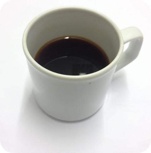 White mug with coffee inside