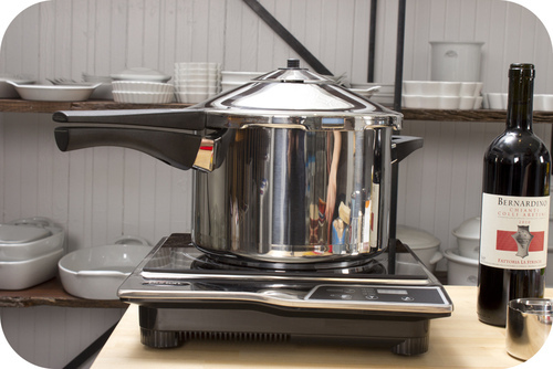 A pressure cooker increases the boiling point of water, which allows for faster cooking