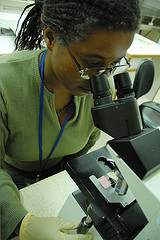 Woman looking through microscope