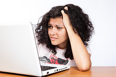 Woman frowning in front of computer