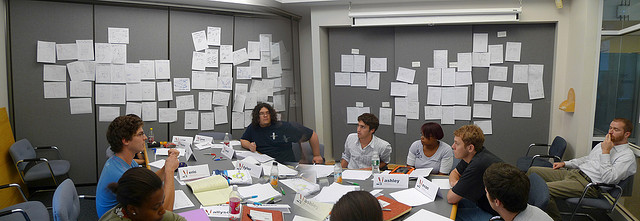 Group at table surrounded by paper