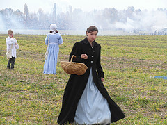 Woman in period dress holding basket