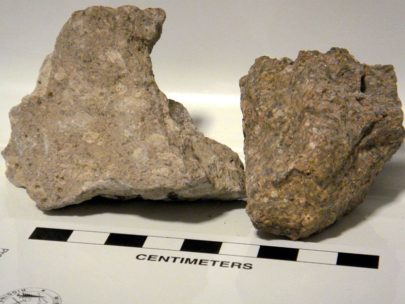 Rocks from the Bishop Tuff, an ignimbrite tuff from Owens River Gorge, California. On the left, a rock from the latter stages of the eruption and the top of the deposit; note large grey, oval pumice fragments. On the right, a rock from the earlier part of the eruption and the bottom of the deposit; note dark, flat fiamme (squished pumice) and apparent increase in phenocrysts, though the compression that caused the fiamme most likely compressed the matrix of the tuff, increasing the apparent abundance of crystals, with respect to the matrix.