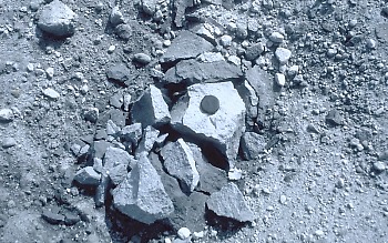 Tephra block (also called a ballistic) on the crater floor of Mount St. Helens about 100 m from the lava dome. This lava fragment was blasted from the dome by a short-lived explosion caused by either (1) a vigorous release of gas from magma within or beneath the dome; or (2) by superheated groundwater