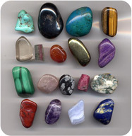 Several gems lined up for the photograph. These gems include jade and other precious rocks.