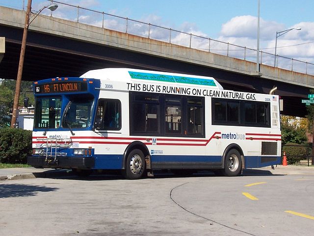 There is a banner on the side of the bus reading 