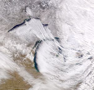 The rising bands of moistened, warmed air that drop lake-effect snow alternate with clear bands of falling cold air. 
