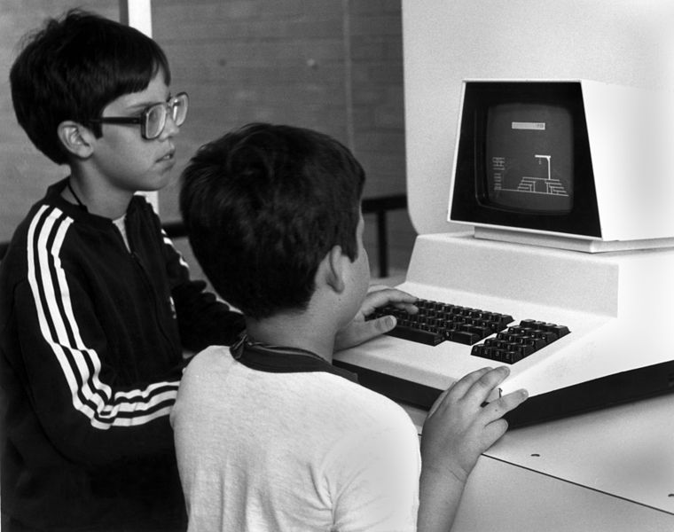 Two young boys playing a game of hangman on a Commodore PET.