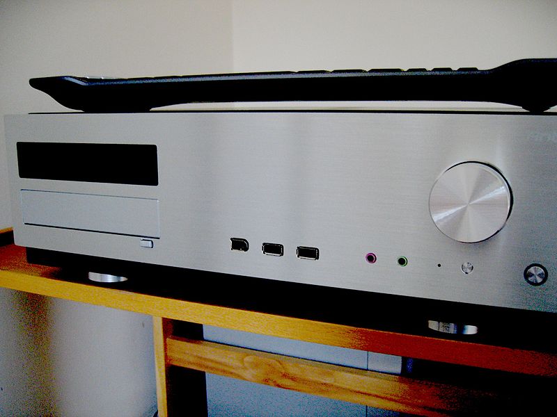The theater has a DVD slot, volume control, USB ports, as well as audio input/output visible