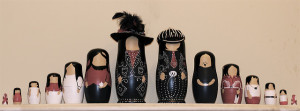 Photo of two sets of nesting dolls, lined up with the largest dolls in the middle, leading out to the smallest at each end