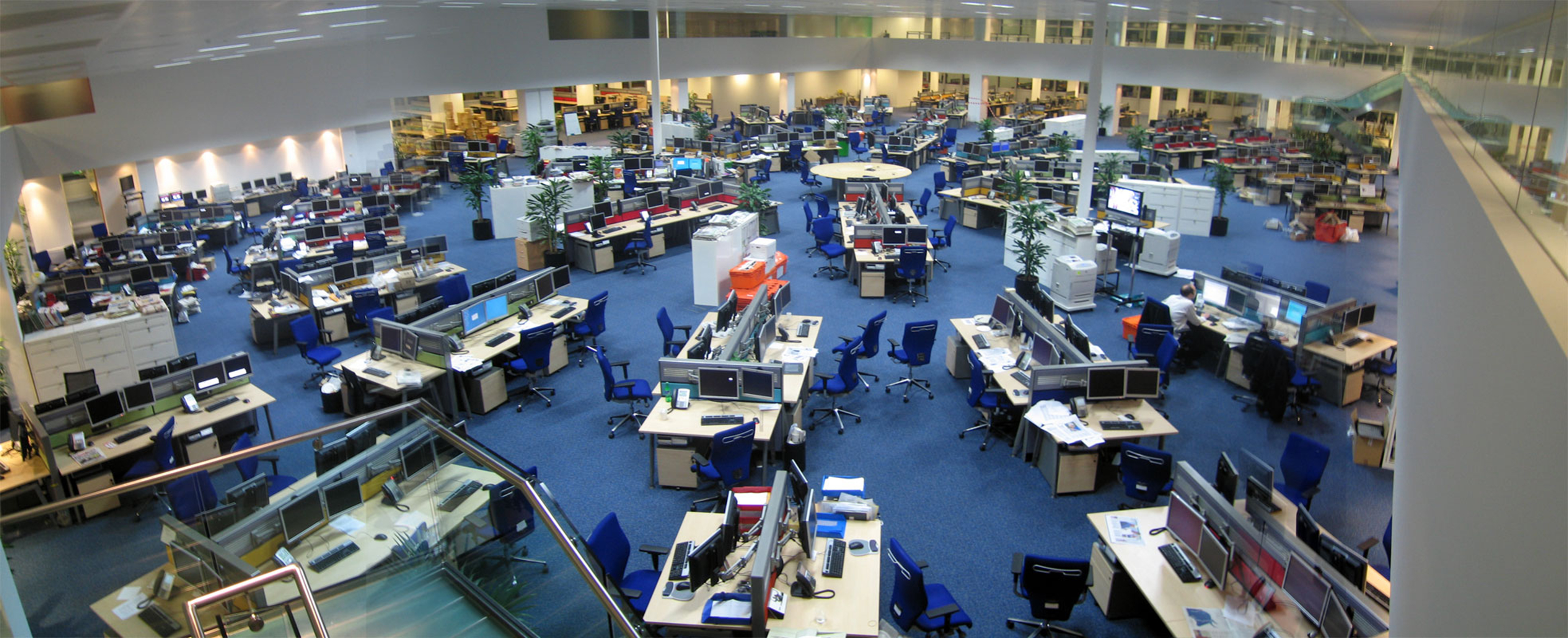This photo shows a large open news room with enough space to seat about 200 employees.