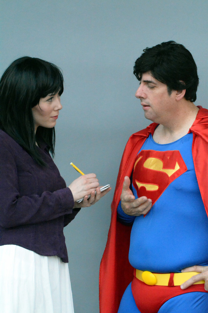 Woman dressed like Lois Lane interviewing a man in a Superman costume