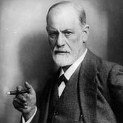 Freud photograph. He has a stern look on his face, a short, white beard, and a cigar in his hand.