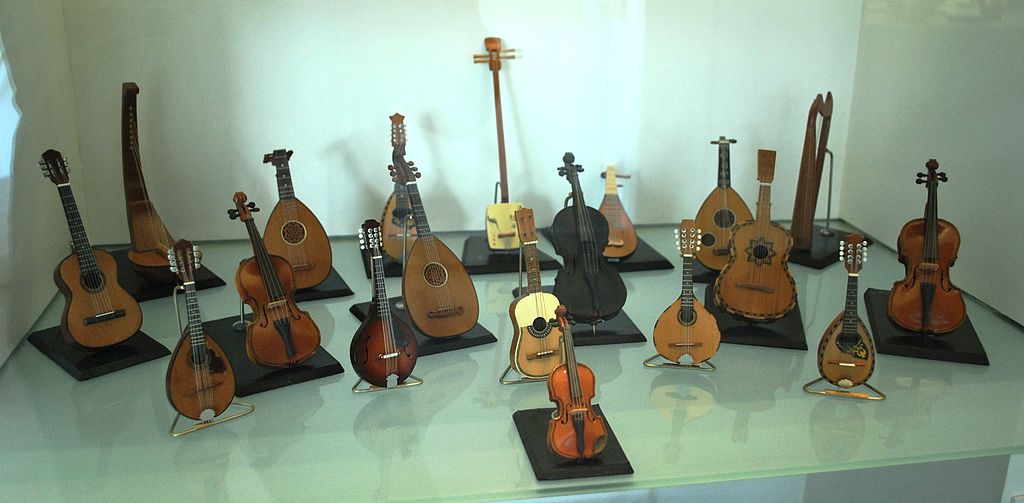 A display of folk string instruments such as guitars and violins