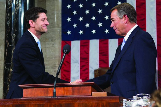 An image of John Boehner shaking hands with Paul Ryan.