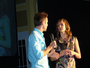 Man interviewing a woman on a stage