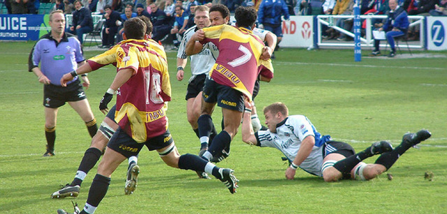 Rugby players colliding during a rugby match.