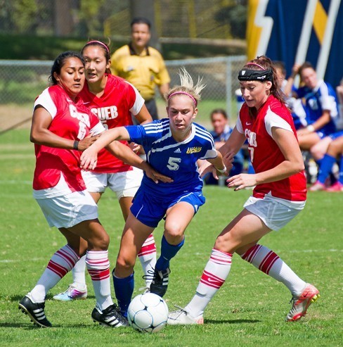 Two teams playing soccer.