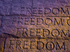 The word freedom etched in stone four times.