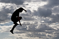 An unsteady person on a tightrope