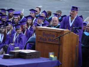 A person delivering a high school graduation speech